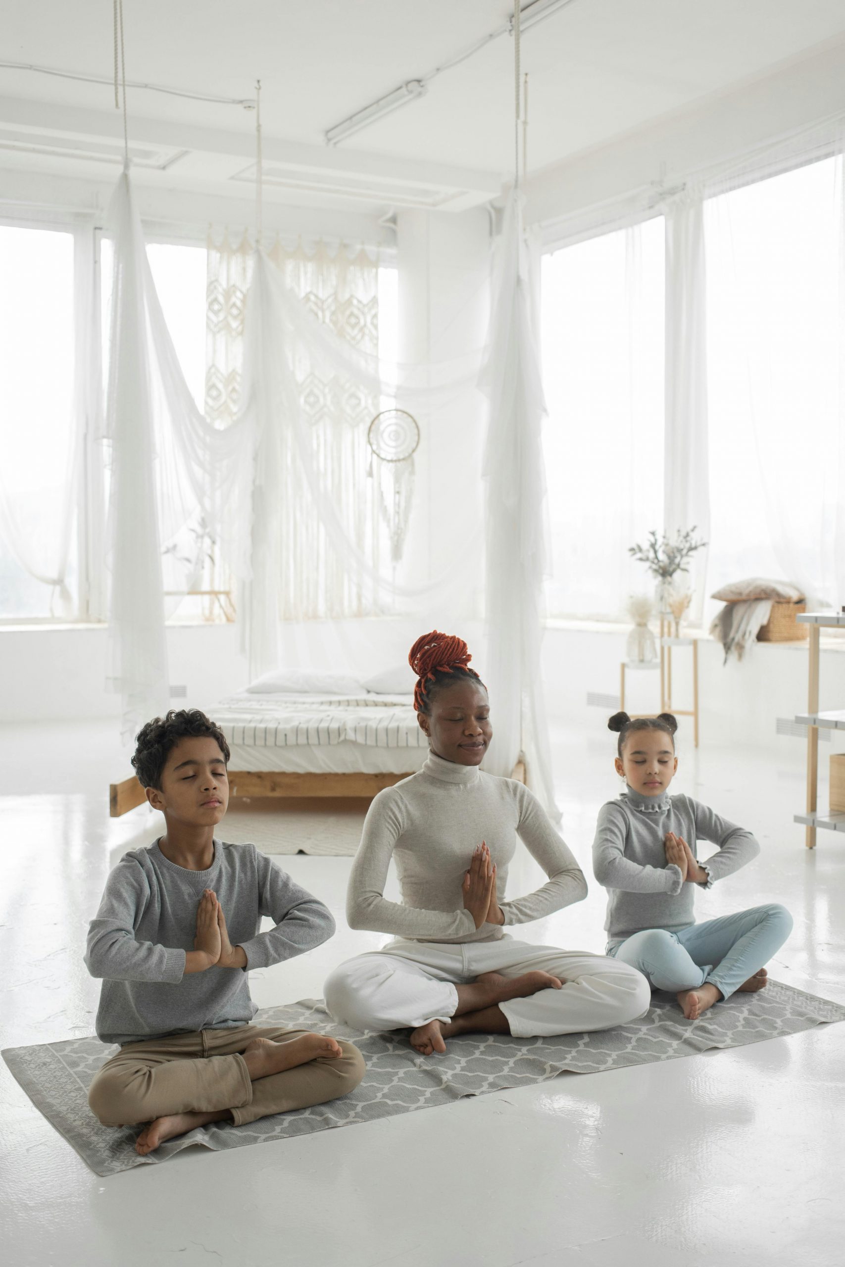 Mother doing yoga with her children